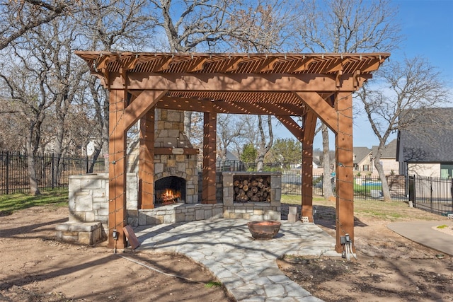 view of patio / terrace with an outdoor stone fireplace and a pergola