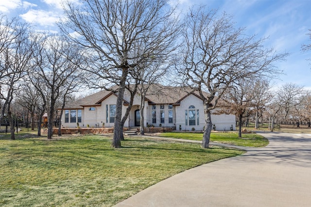 ranch-style home featuring a front yard