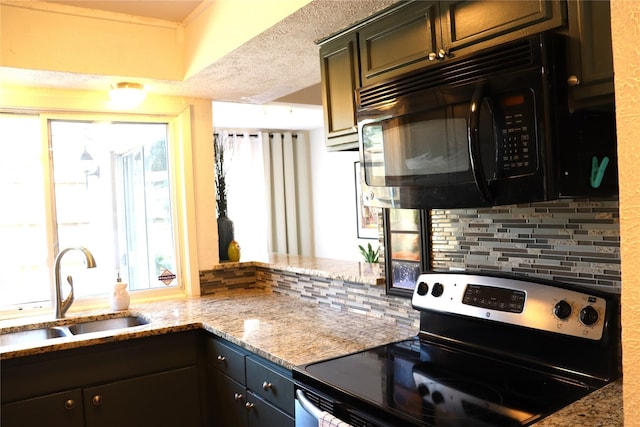 kitchen featuring a textured ceiling, light stone countertops, stainless steel electric stove, and sink