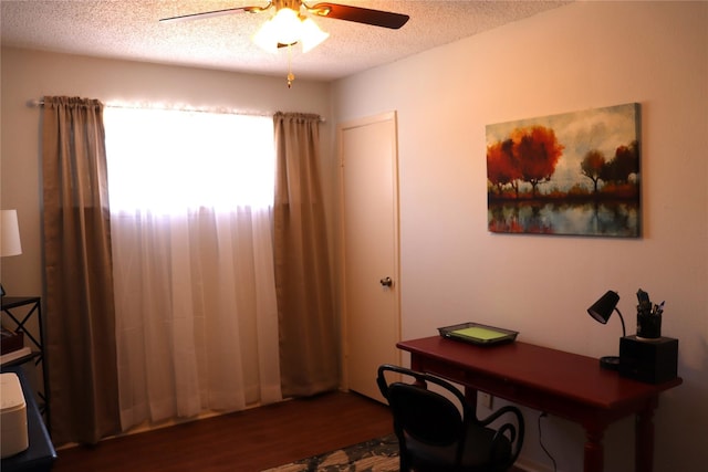 office area with ceiling fan, dark hardwood / wood-style flooring, and a textured ceiling