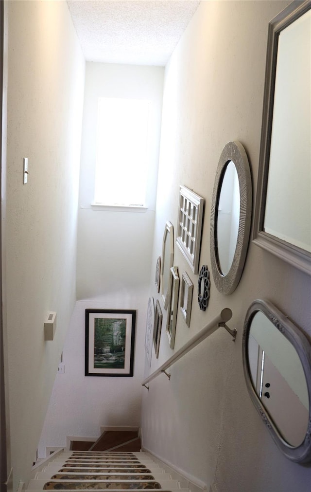 stairway with a textured ceiling