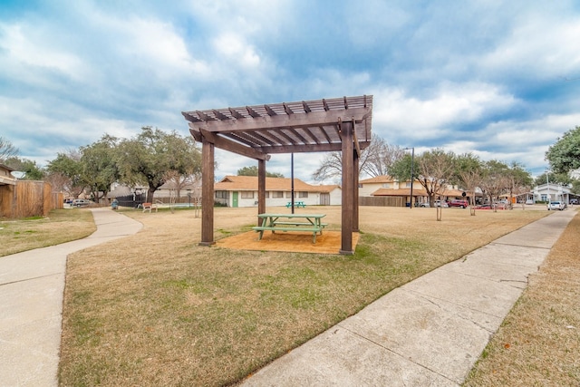 view of community with a yard and a pergola