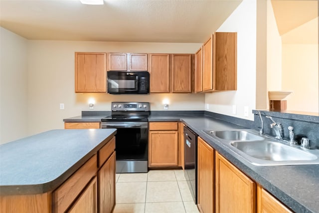 kitchen featuring sink, light tile patterned floors, and black appliances