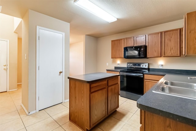 kitchen featuring sink, stainless steel electric range, a center island, and light tile patterned floors