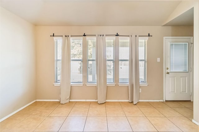 interior space featuring lofted ceiling and light tile patterned floors