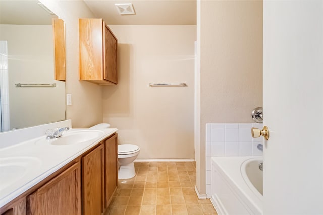 bathroom featuring a bath, vanity, and toilet