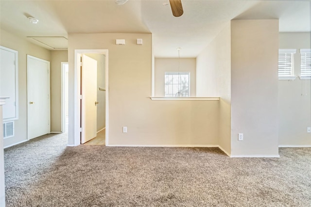 carpeted spare room with ceiling fan