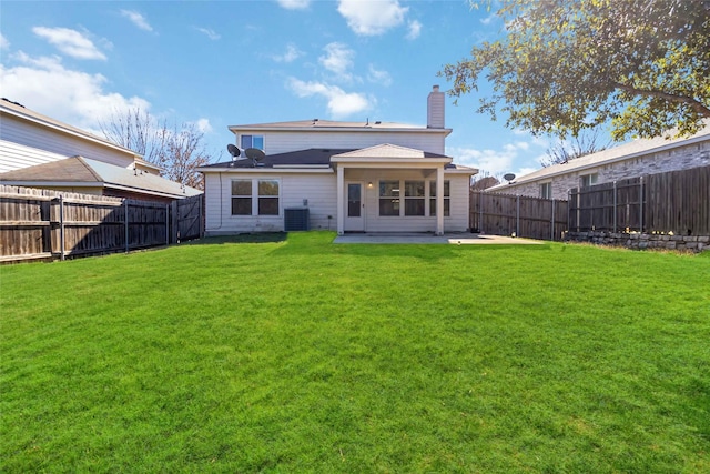 back of property with a patio area, central AC unit, and a yard