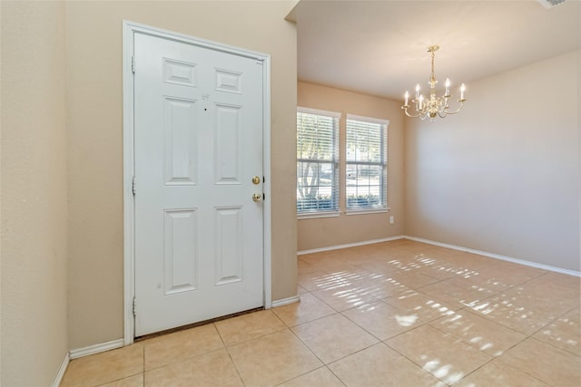 tiled entryway with an inviting chandelier