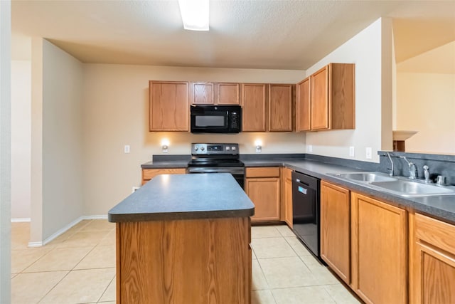 kitchen featuring black appliances, a center island, light tile patterned flooring, and sink