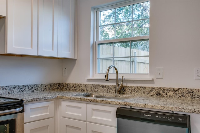 kitchen featuring white cabinets, light stone countertops, sink, and appliances with stainless steel finishes