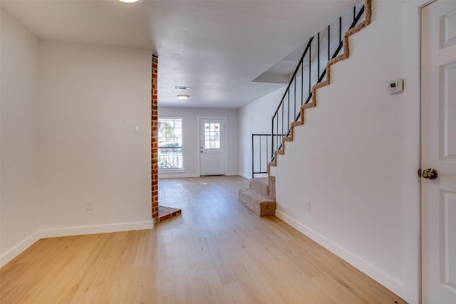 foyer entrance with light wood-type flooring