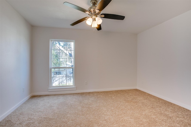 spare room featuring light carpet and ceiling fan