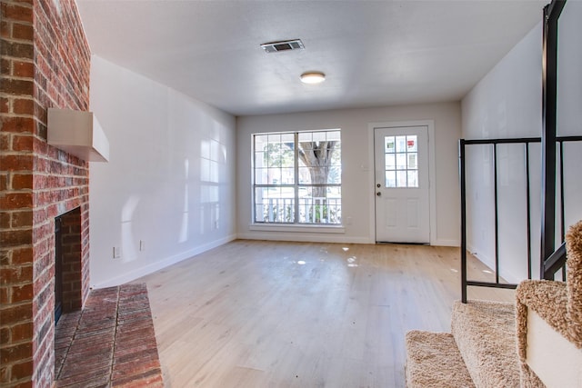 unfurnished living room featuring light wood-type flooring