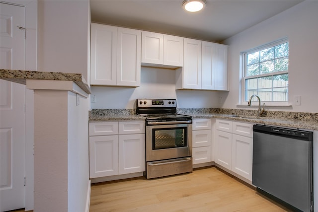 kitchen featuring white cabinetry, appliances with stainless steel finishes, and light hardwood / wood-style flooring