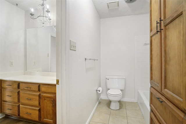 full bathroom featuring tile patterned flooring, a chandelier, a textured ceiling, toilet, and vanity