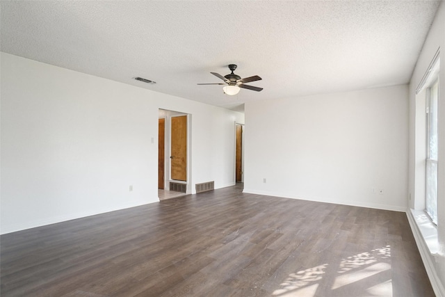 unfurnished room featuring a textured ceiling, ceiling fan, and dark wood-type flooring