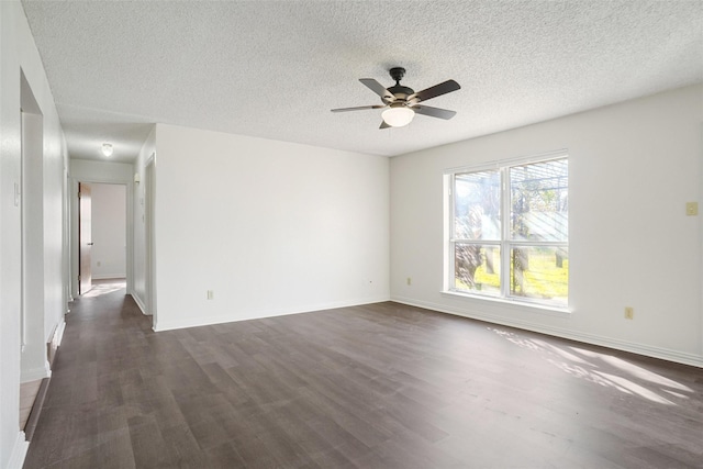 spare room with ceiling fan, dark wood-type flooring, and a textured ceiling