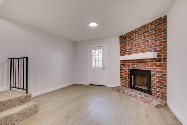 unfurnished living room featuring a fireplace and light wood-type flooring