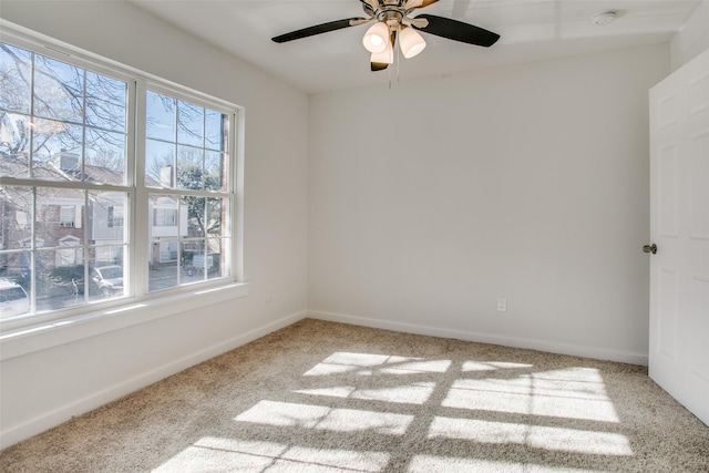 empty room with carpet flooring, ceiling fan, and a healthy amount of sunlight