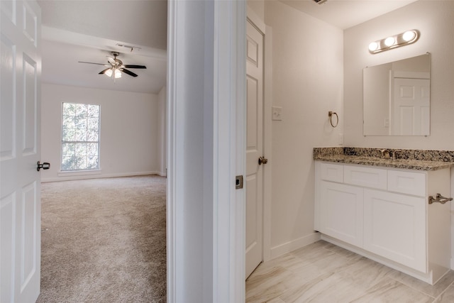 bathroom with ceiling fan and vanity