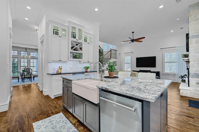 kitchen with white cabinets, dishwasher, sink, and a kitchen island with sink