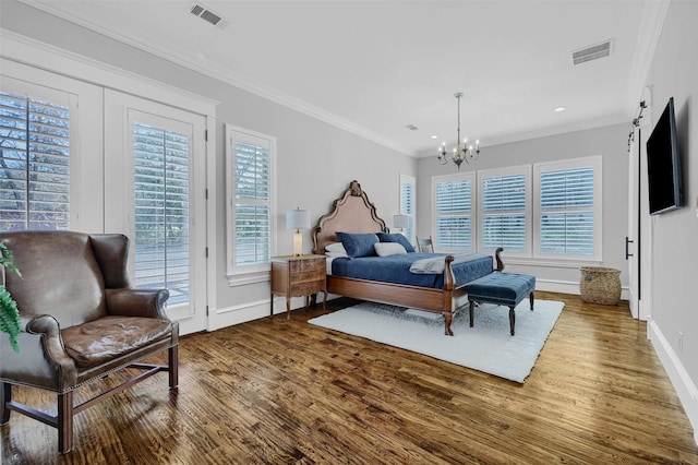 bedroom featuring hardwood / wood-style floors, a notable chandelier, and ornamental molding