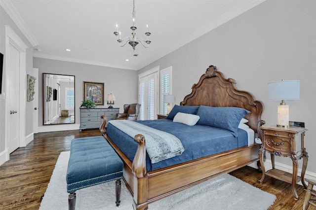 bedroom featuring ornamental molding, dark wood-type flooring, and an inviting chandelier