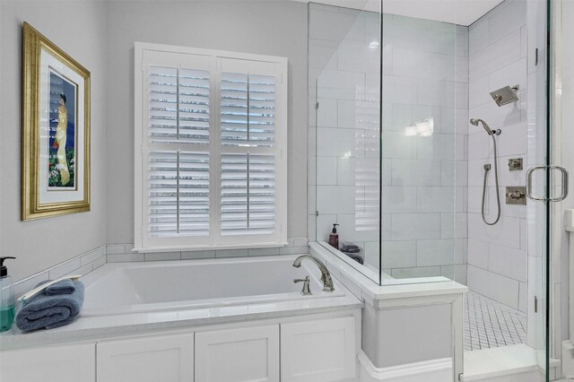 bathroom featuring separate shower and tub