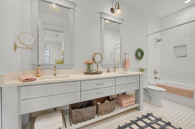 full bathroom with toilet, tile patterned flooring, vanity, and tiled shower / bath