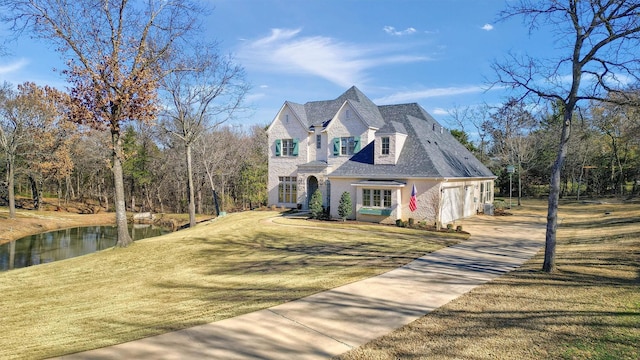 french country style house featuring a front yard