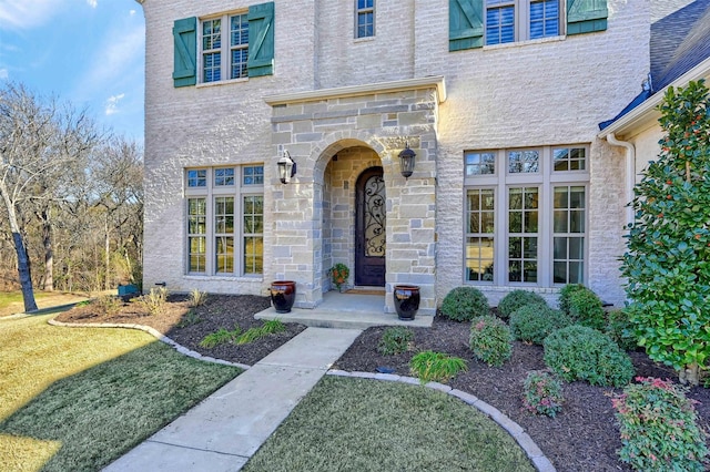 doorway to property featuring a yard