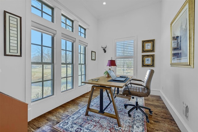 office with plenty of natural light, crown molding, and dark wood-type flooring