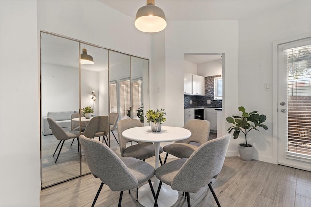 dining space with light hardwood / wood-style flooring