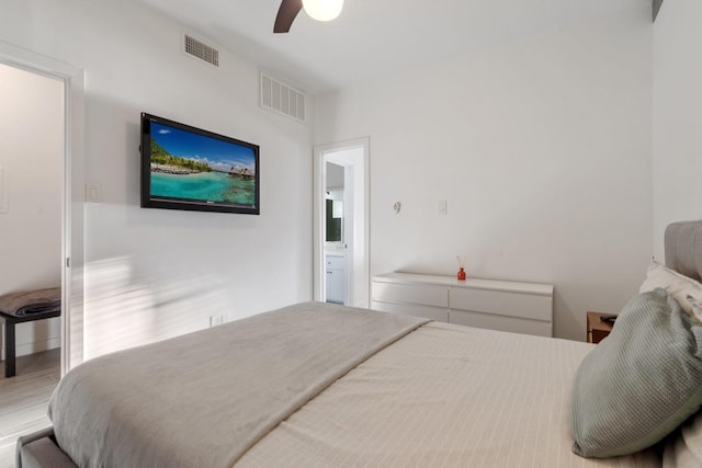 bedroom featuring ceiling fan and ensuite bath