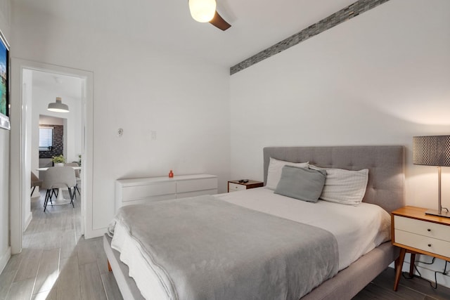 bedroom with hardwood / wood-style floors and ceiling fan