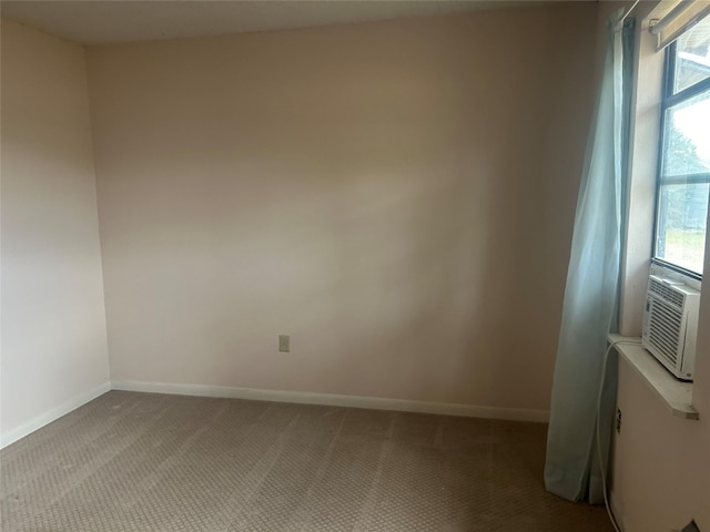 carpeted spare room with cooling unit and a wealth of natural light