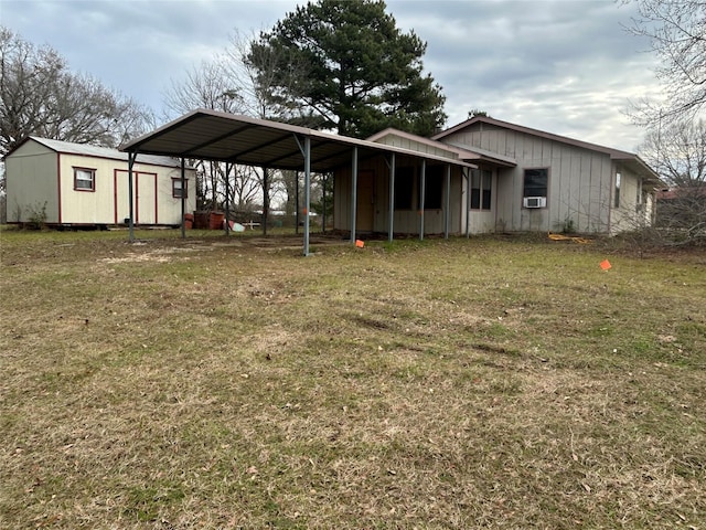 back of property with cooling unit, a carport, a yard, and a shed