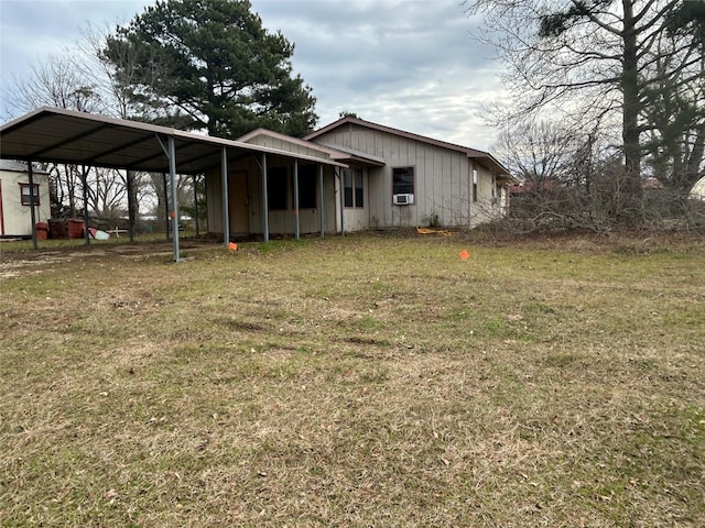 exterior space with a carport and a lawn