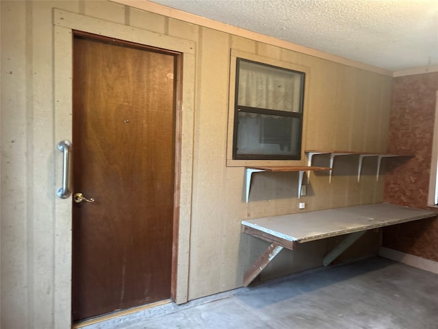 interior space with concrete flooring and a textured ceiling