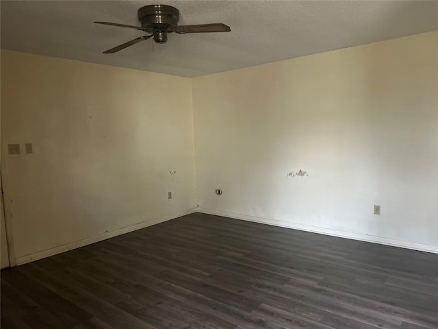 spare room featuring ceiling fan and dark wood-type flooring