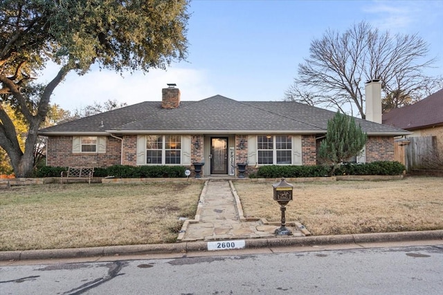 single story home with a front lawn