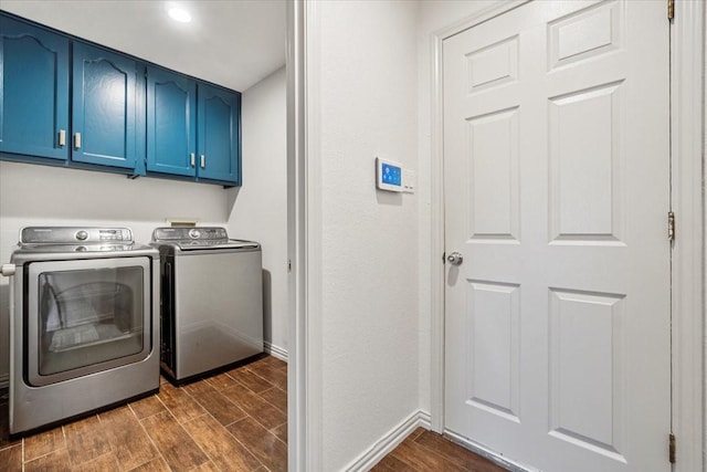 washroom featuring separate washer and dryer and cabinets