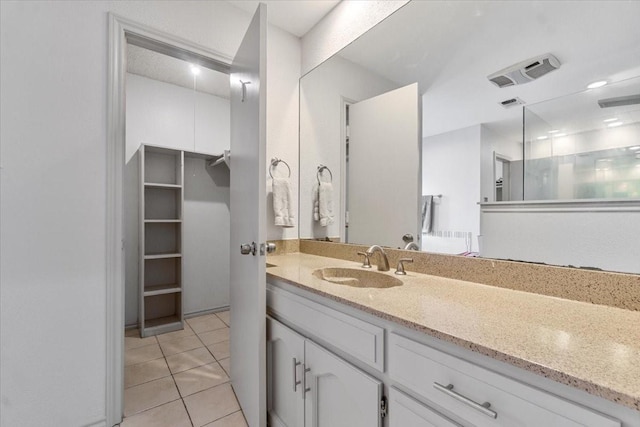 bathroom with tile patterned floors and vanity