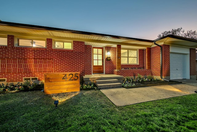 view of front of house with a yard and a garage