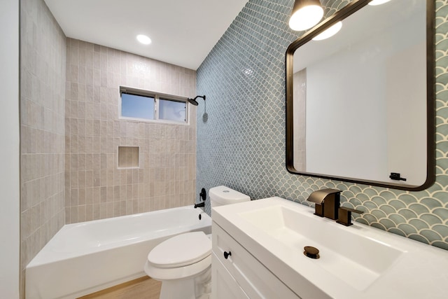 full bathroom with vanity, toilet, and tiled shower / bath