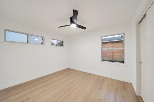 empty room featuring ceiling fan and light hardwood / wood-style floors