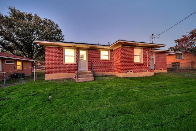 view of front facade featuring a yard and central AC unit