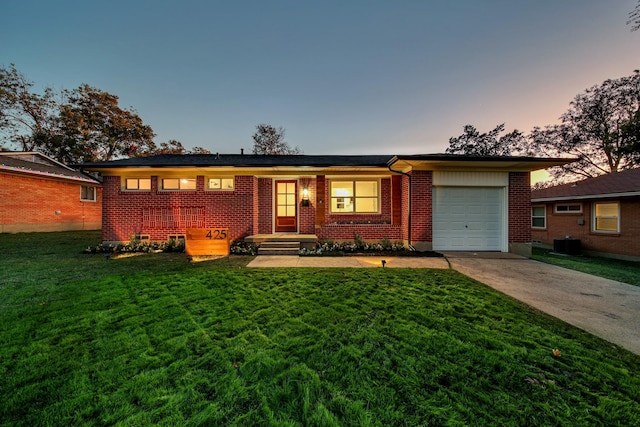 single story home featuring central AC, a yard, and a garage