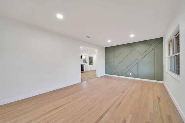 empty room with light hardwood / wood-style flooring